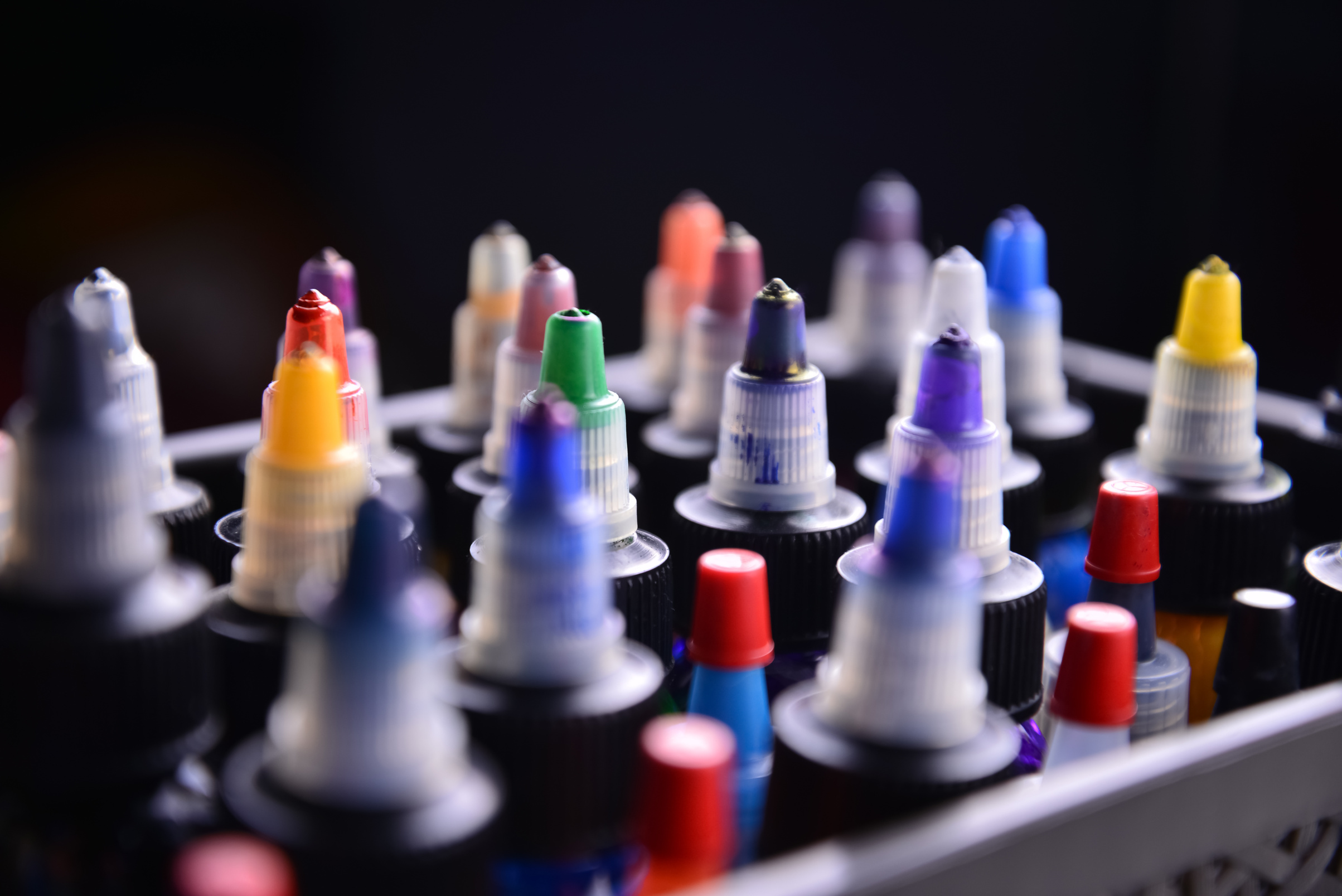 Tattoo  color ink bottles isolated on black background